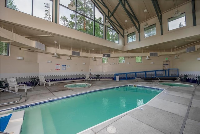 pool with a patio area and a ceiling fan