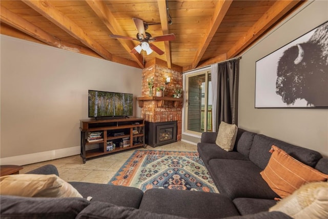 living area with baseboards, beamed ceiling, a large fireplace, ceiling fan, and wooden ceiling