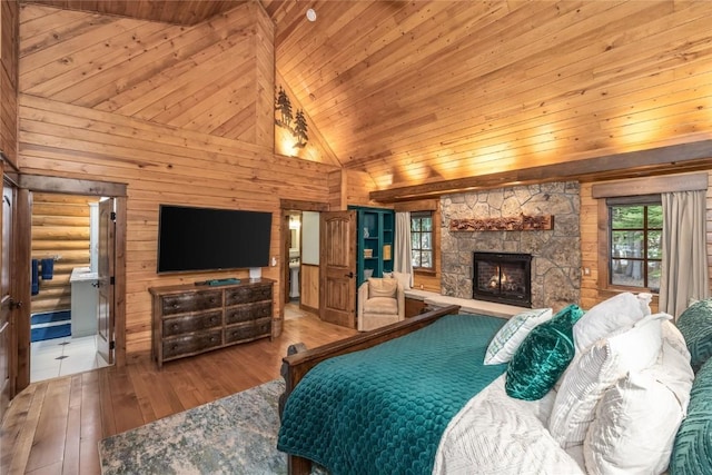 486 Sage Creek Canyon Dr, Silverthorne, CO 80498 - bedroom featuring wooden ceiling, hardwood / wood-style floors, a stone fireplace, wooden walls, and high vaulted ceiling