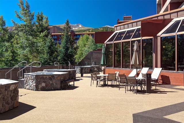 view of patio / terrace featuring a fire pit and a mountain view