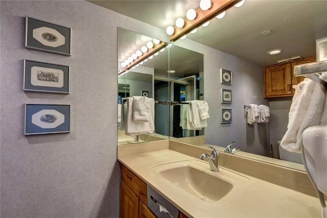 bathroom featuring a textured wall and vanity