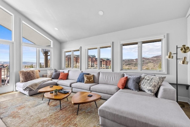 1724 Ski Time Square Dr Unit R6, Steamboat Springs, CO 80487 - living room with healthy amount of natural light, lofted ceiling, wood finished floors, and recessed lighting