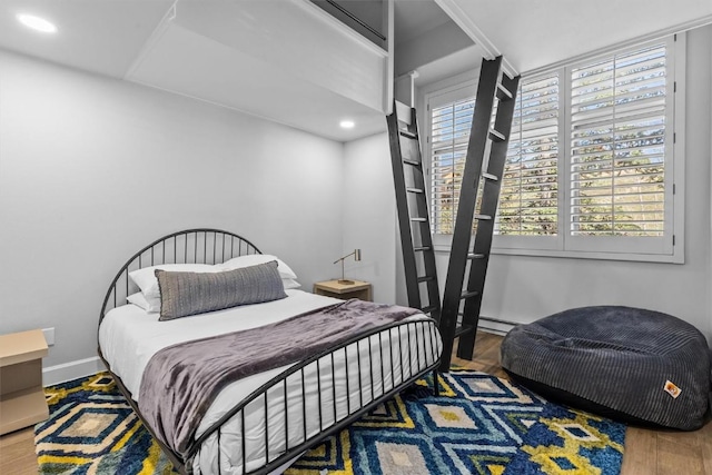 1724 Ski Time Square Dr Unit R6, Steamboat Springs, CO 80487 - bedroom featuring wood finished floors, recessed lighting, and a baseboard radiator