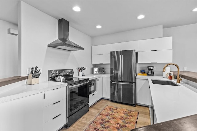 1724 Ski Time Square Dr Unit R6, Steamboat Springs, CO 80487 - kitchen featuring appliances with stainless steel finishes, wall chimney range hood, a sink, modern cabinets, and white cabinets
