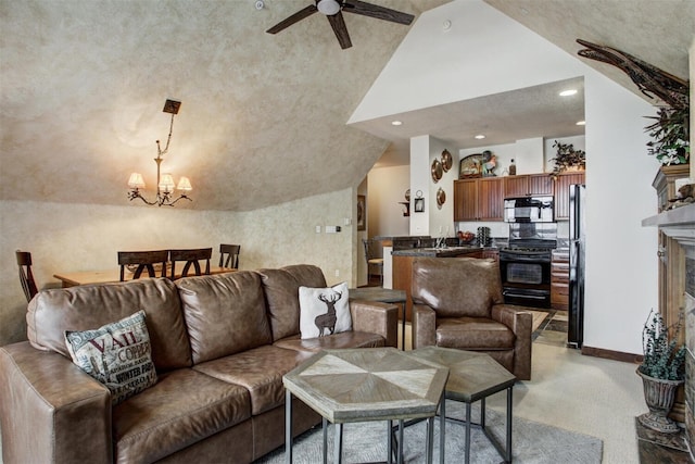 living room featuring recessed lighting, a high end fireplace, vaulted ceiling, light carpet, and ceiling fan with notable chandelier