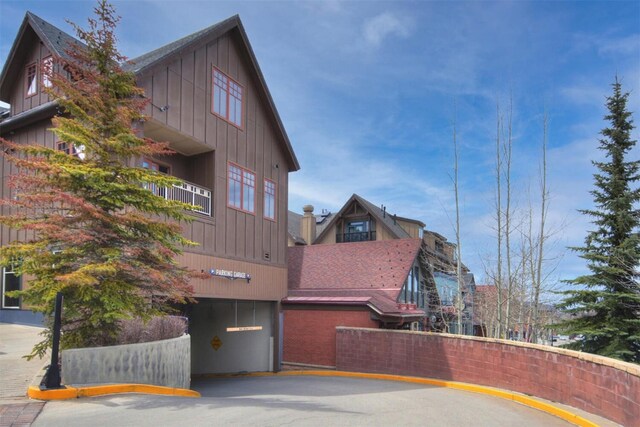 view of property exterior with board and batten siding and a balcony