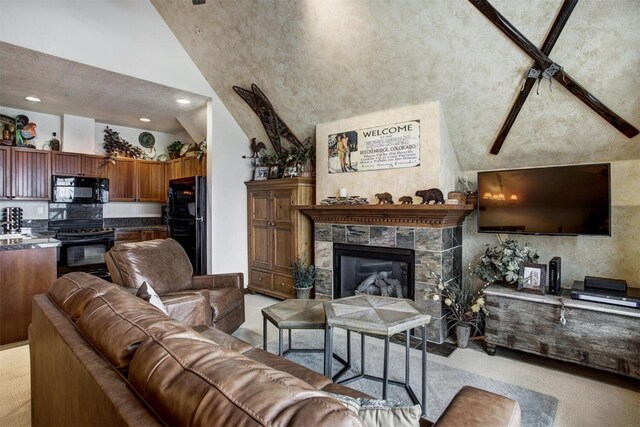 living area featuring a tiled fireplace, high vaulted ceiling, recessed lighting, and light colored carpet