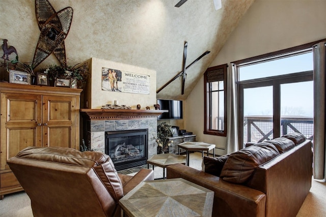 living room with a wealth of natural light, ceiling fan, light carpet, and a fireplace