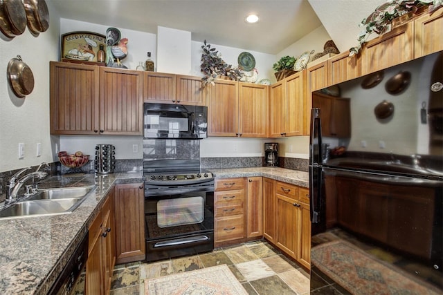 kitchen with stone finish floor, a sink, recessed lighting, and black appliances