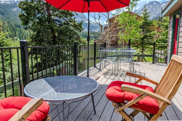46 Mcdill Rd, Breckenridge, CO 80424 - deck with outdoor dining area, a mountain view, and a view of trees