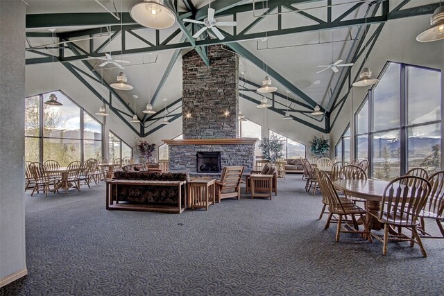 8500 Ryan Gulch Rd Unit G2, Wildernest, CO 80498 - carpeted dining space featuring a high ceiling, a ceiling fan, and an outdoor stone fireplace