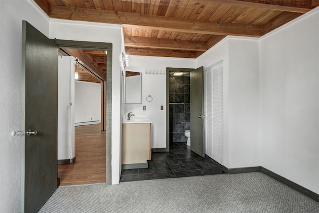 8500 Ryan Gulch Rd Unit G2, Wildernest, CO 80498 - bathroom with wooden ceiling with exposed beams, toilet, vanity, baseboards, and tile patterned floors