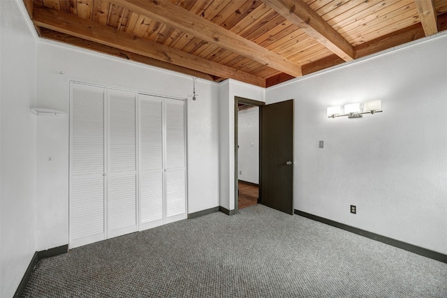 8500 Ryan Gulch Rd Unit G2, Wildernest, CO 80498 - unfurnished bedroom featuring wood ceiling with exposed beams, carpet floors, a closet, and baseboards