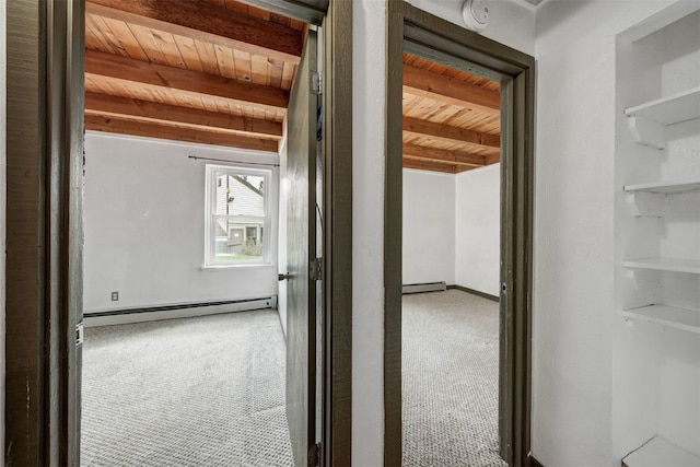 8500 Ryan Gulch Rd Unit G2, Wildernest, CO 80498 - hallway featuring wood ceiling with exposed beams, a baseboard heating unit, carpet flooring, and baseboards