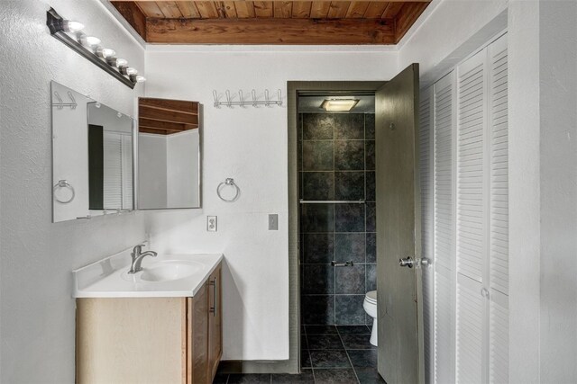 8500 Ryan Gulch Rd Unit G2, Wildernest, CO 80498 - full bathroom with a closet, toilet, wooden ceiling, vanity, and tile patterned flooring
