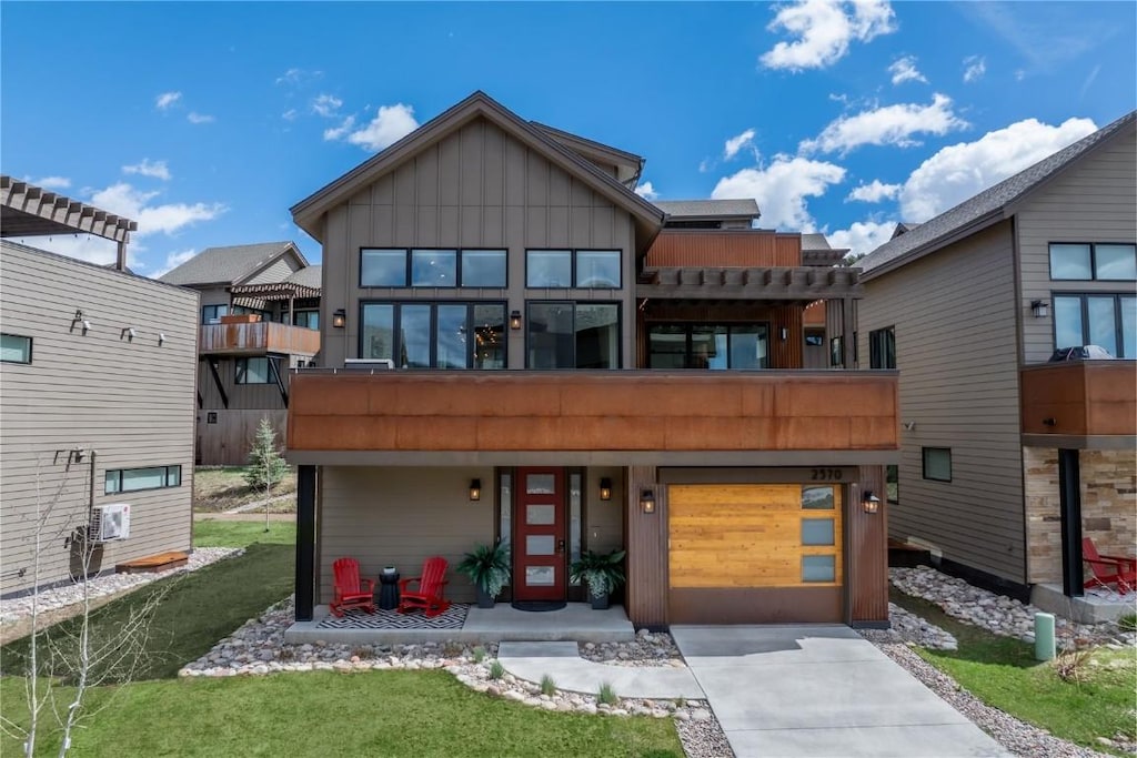 2570 Flat Tops Ct, Steamboat Springs, CO 80487 - back of house with driveway, board and batten siding, a garage, and a balcony