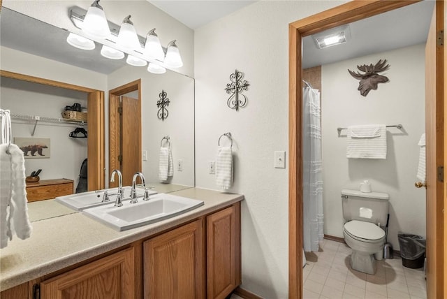 full bathroom featuring tile patterned flooring, vanity, toilet, and baseboards