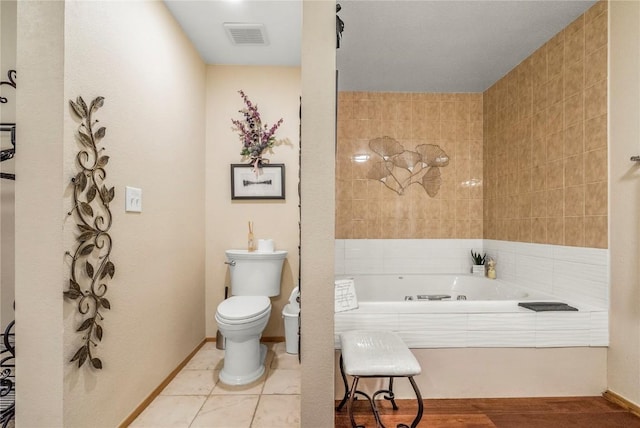 full bathroom with a bath and toilet
