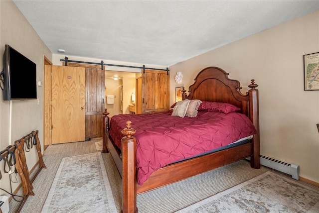 bedroom with a baseboard radiator, connected bathroom, light carpet, a barn door, and baseboards