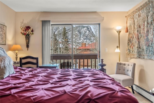 bedroom with baseboard heating, access to exterior, and carpet