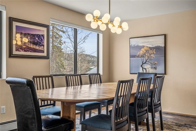 dining space featuring a chandelier, dark wood-type flooring, a baseboard radiator, and baseboards