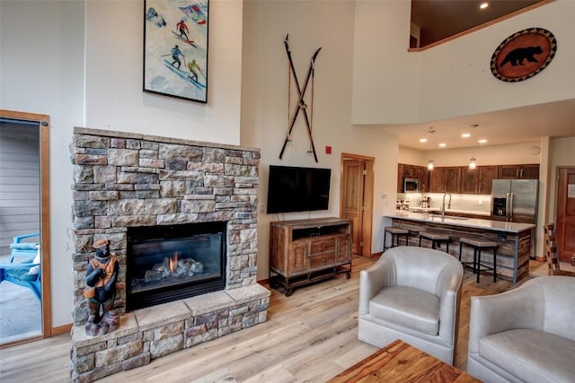 23110 US Highway 6 Unit 319, Keystone, CO 80435 - living room with a fireplace and light wood-style flooring