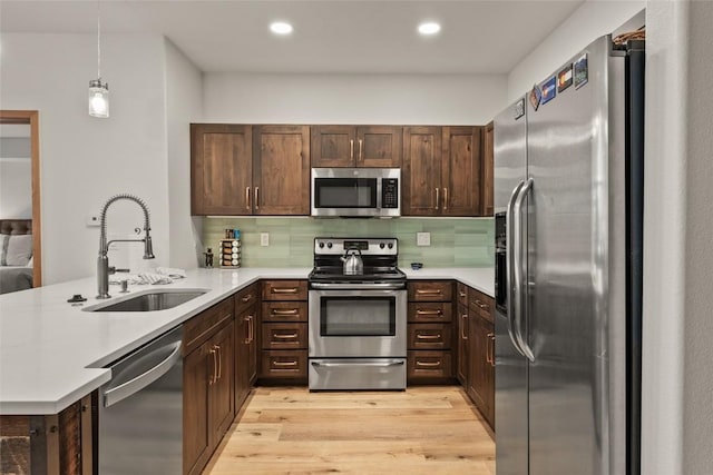 23110 US Highway 6 Unit 319, Keystone, CO 80435 - kitchen featuring stainless steel appliances, a peninsula, light countertops, backsplash, and recessed lighting