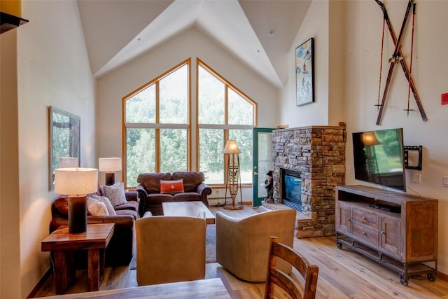 23110 US Highway 6 Unit 319, Keystone, CO 80435 - living room with light wood-type flooring, a stone fireplace, and high vaulted ceiling