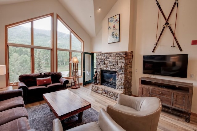 23110 US Highway 6 Unit 319, Keystone, CO 80435 - living room with light wood-type flooring, a fireplace, and vaulted ceiling