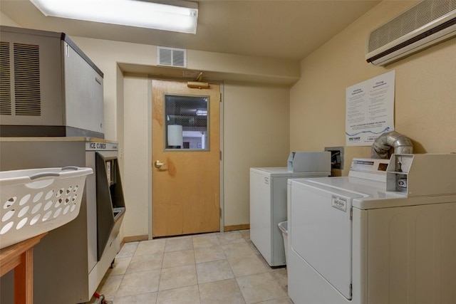 23110 US Highway 6 Unit 319, Keystone, CO 80435 - communal laundry room with an AC wall unit, washing machine and dryer, and light tile patterned flooring