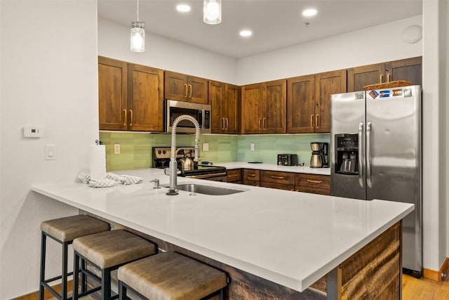 23110 US Highway 6 Unit 319, Keystone, CO 80435 - kitchen with appliances with stainless steel finishes, a peninsula, light countertops, backsplash, and recessed lighting