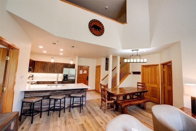 23110 US Highway 6 Unit 319, Keystone, CO 80435 - dining space featuring light wood-style flooring, recessed lighting, stairs, and a high ceiling