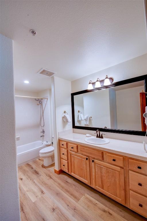 23110 US Highway 6 Unit 319, Keystone, CO 80435 - full bath featuring wood finished floors, vanity, and  shower combination