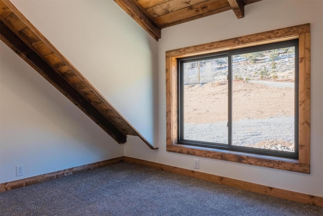 interior space with wood ceiling, lofted ceiling with beams, carpet floors, and baseboards