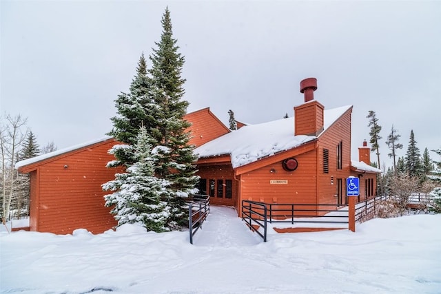 91200 Ryan Gulch Rd Unit 91223, Silverthorne, CO 80498 - snow covered back of property featuring a chimney