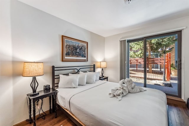 bedroom featuring access to exterior and dark wood-type flooring