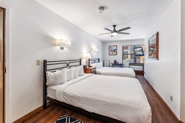 bedroom featuring ceiling fan and dark wood-type flooring