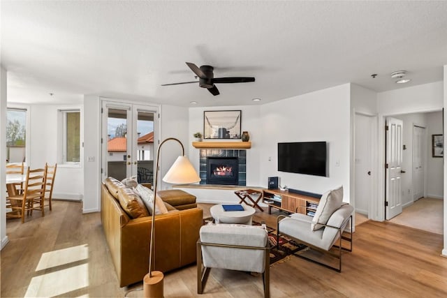 2700 Eagleridge Dr Unit N31, Steamboat Springs, CO 80487 - living room with a tile fireplace, light wood-style flooring, and healthy amount of natural light