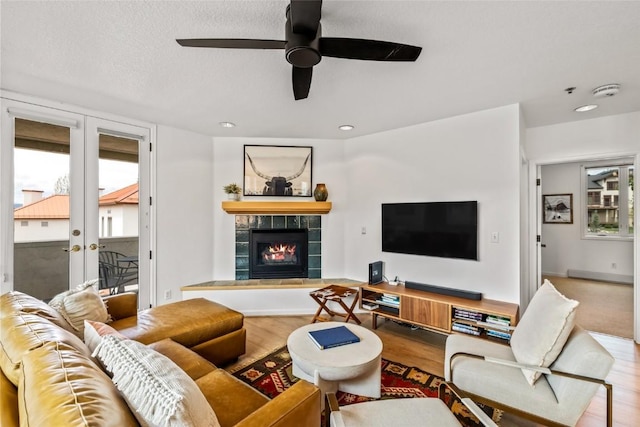 2700 Eagleridge Dr Unit N31, Steamboat Springs, CO 80487 - living room with wood finished floors, a fireplace, ceiling fan, french doors, and recessed lighting