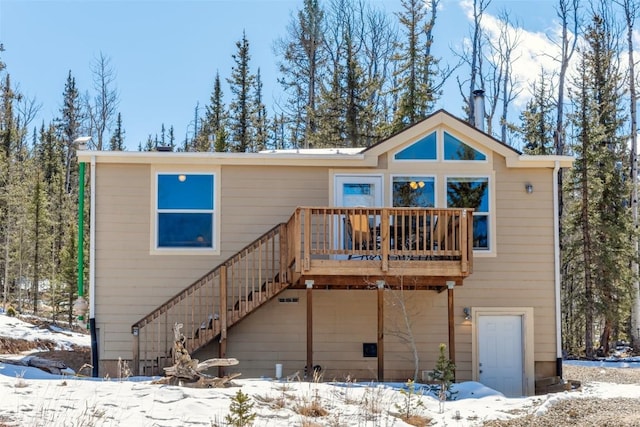 972 N Quarter Horse Rd, Jefferson, CO 80456 - snow covered rear of property with a wooden deck and stairway