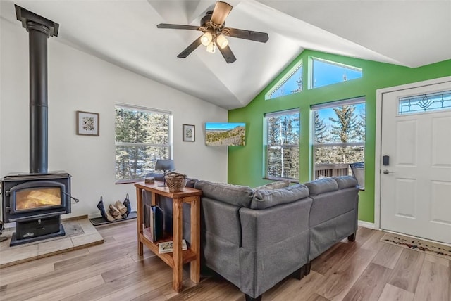 972 N Quarter Horse Rd, Jefferson, CO 80456 - living area with ceiling fan, vaulted ceiling, wood finished floors, and a wood stove