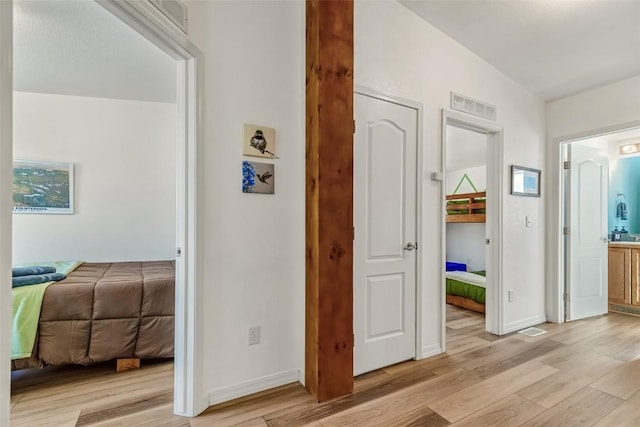 972 N Quarter Horse Rd, Jefferson, CO 80456 - corridor with baseboards, visible vents, and light wood-style floors