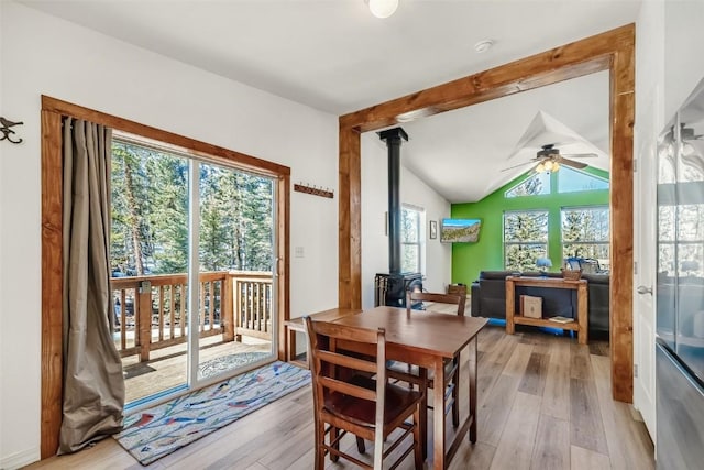 972 N Quarter Horse Rd, Jefferson, CO 80456 - dining room featuring light wood-style flooring, a wood stove, a ceiling fan, and vaulted ceiling with beams