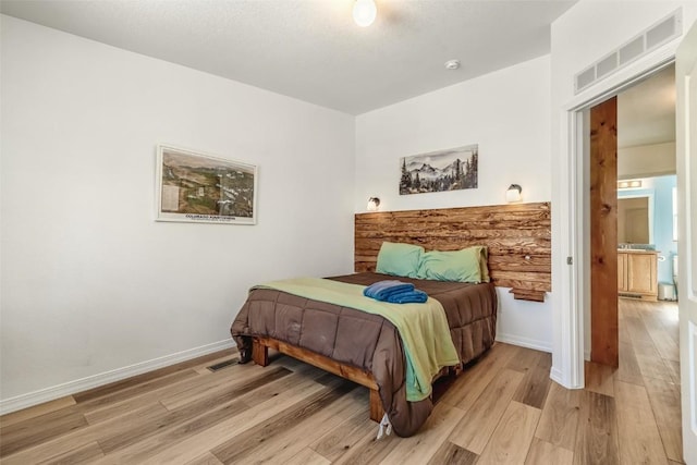 972 N Quarter Horse Rd, Jefferson, CO 80456 - bedroom featuring baseboards, light wood-style floors, and visible vents