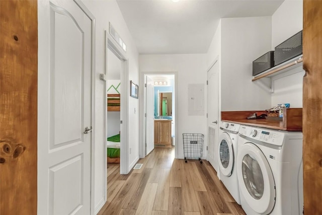 972 N Quarter Horse Rd, Jefferson, CO 80456 - washroom with washer and dryer, laundry area, light wood-style flooring, baseboards, and visible vents
