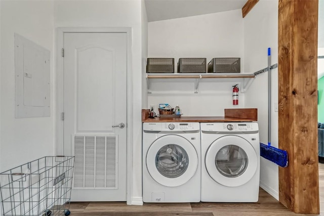 972 N Quarter Horse Rd, Jefferson, CO 80456 - laundry area with laundry area, wood finished floors, visible vents, electric panel, and washing machine and clothes dryer