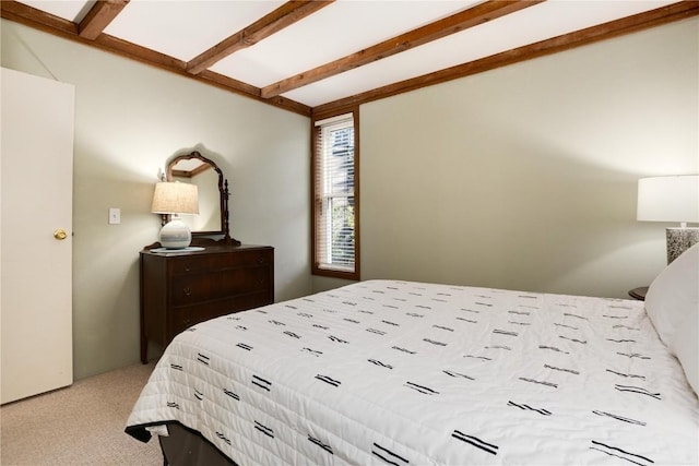 bedroom with beamed ceiling and carpet