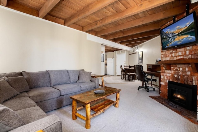 living area featuring wood ceiling, carpet, a brick fireplace, and beam ceiling