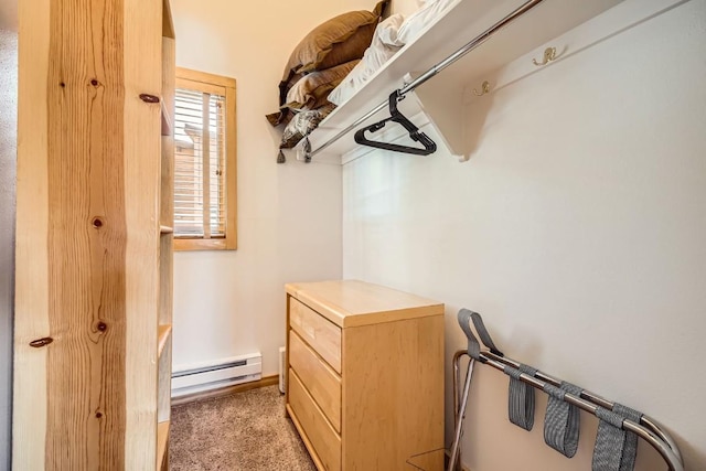 spacious closet featuring a baseboard radiator and carpet floors