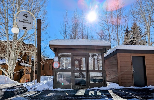 view of snow covered property entrance